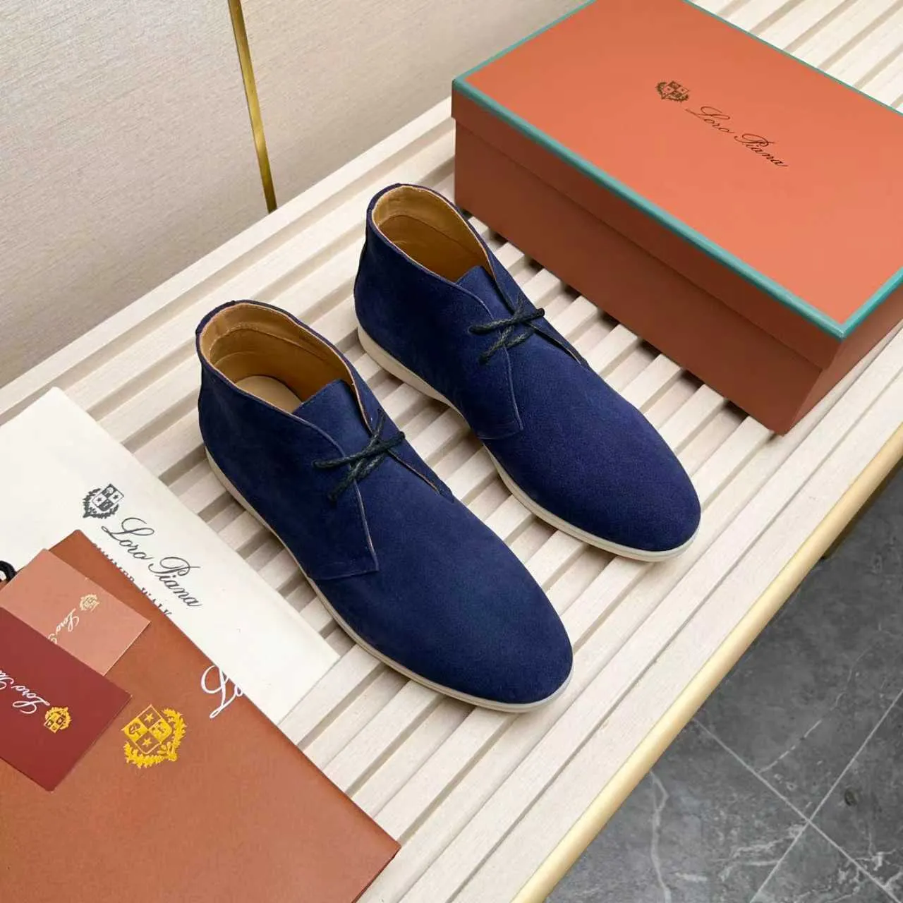 Men's Shoes 💰420 Loro Piana reimagines the desert boot—a modern, comfortable interpretation of a classic 1940s style. Crafted from suede calfskin, it exudes elegance. The tight texture of suede calfskin is not only durable but also looks casual and sophisticated. Add a timeless piece to your shoe collection, harmoniously blending comfort, style and Loro Piana's heritage of craftsmanship. Acetate satin detail on the inside White sole with LP lettering for added traction Space for a personalized signature on the heel Tonal suede trim Upper: 100% cow split suede Sole: 100% Rubber lining: Cow leather
